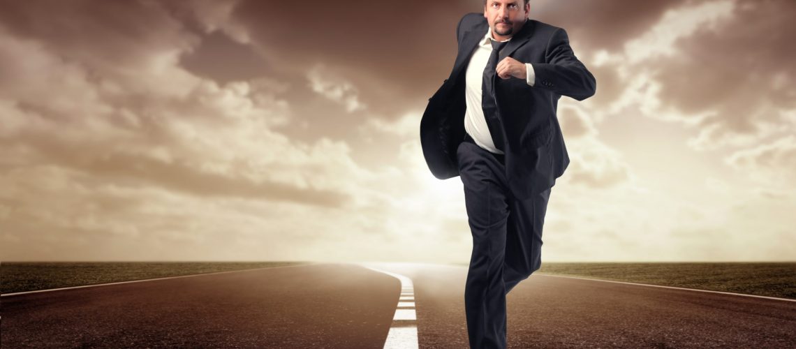 business man running isolated on the road